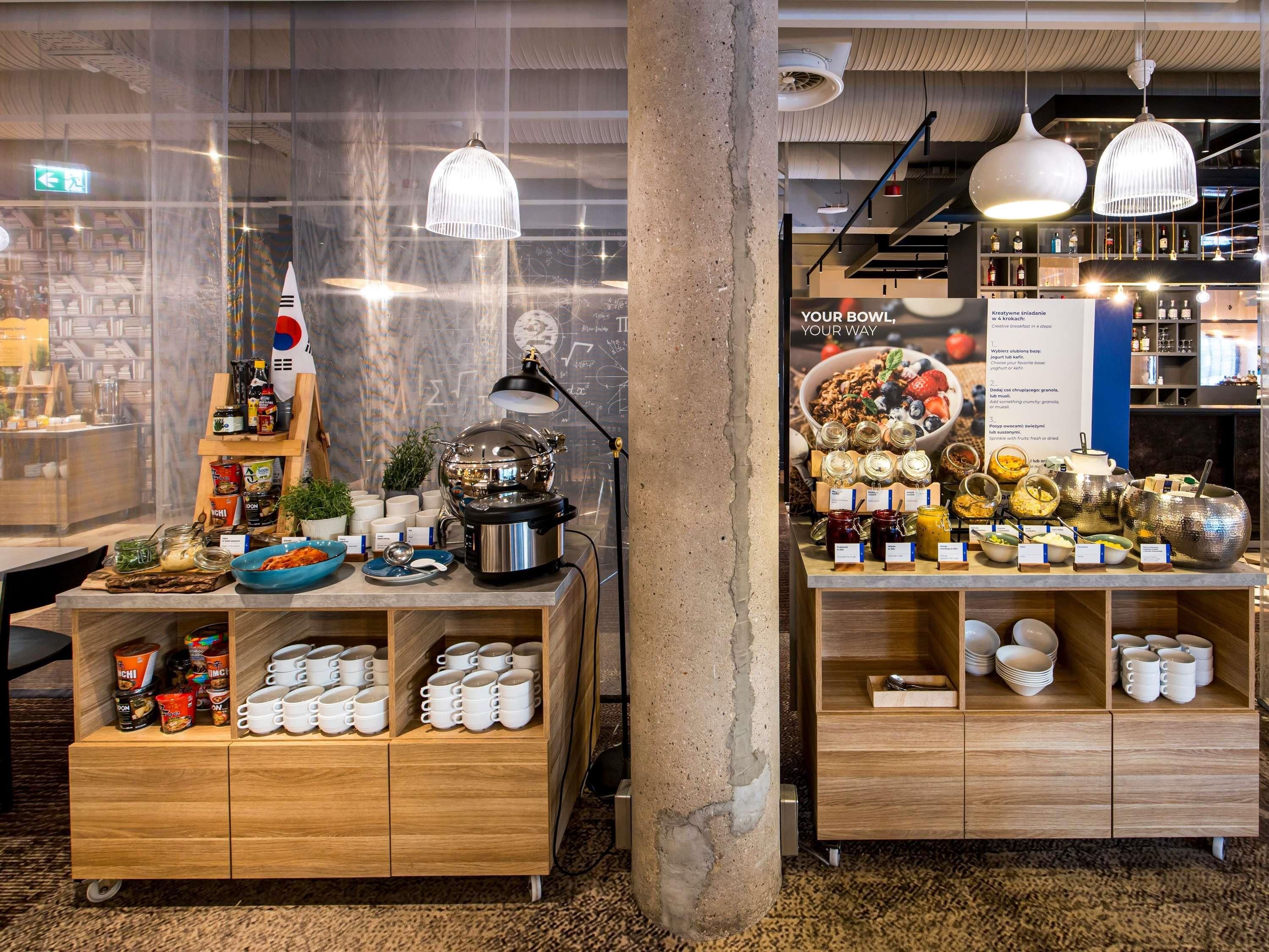 A café with a coffee station, a display of jars and bowls, and a menu board.