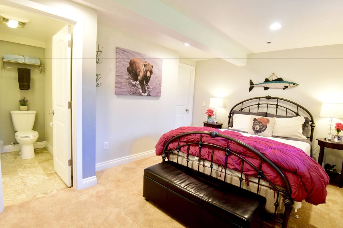 A bedroom with a bed, a bathroom with a toilet, and a hallway.