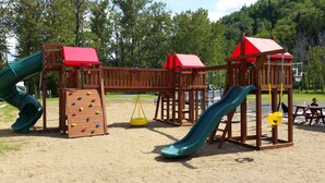 A playground with slides, climbing walls, and swings.