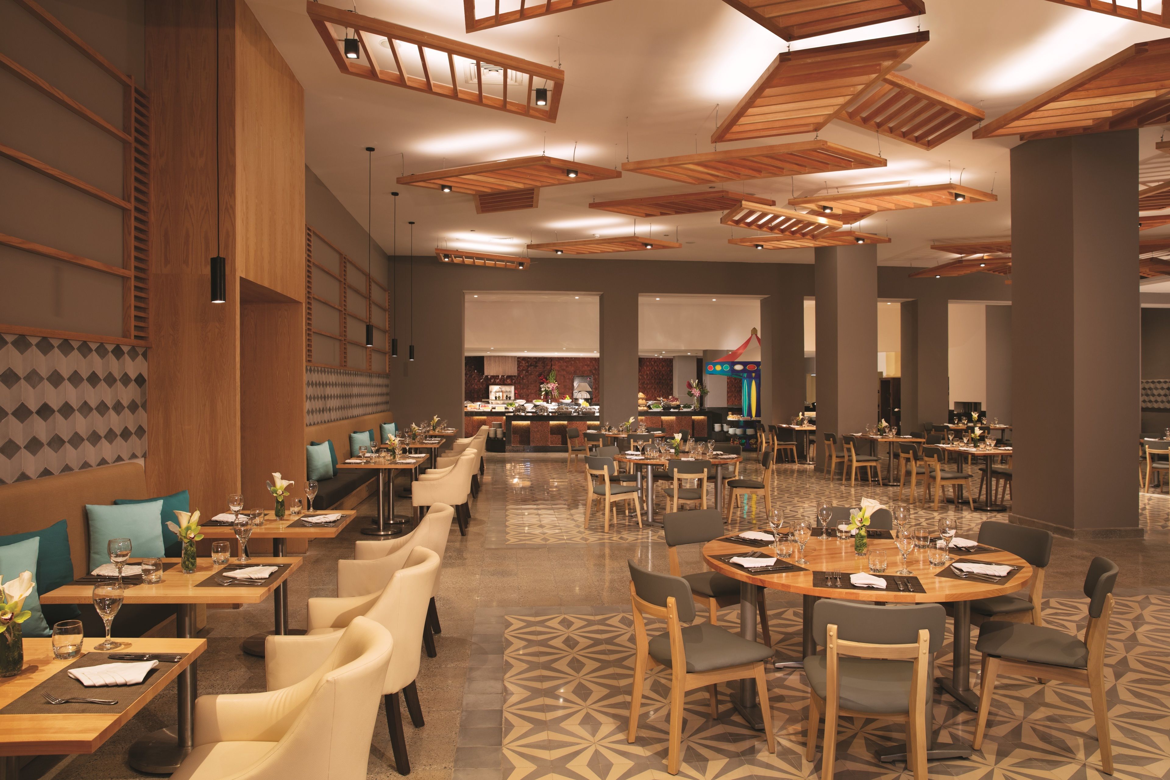 A spacious restaurant with multiple dining areas, including a bar and a buffet.