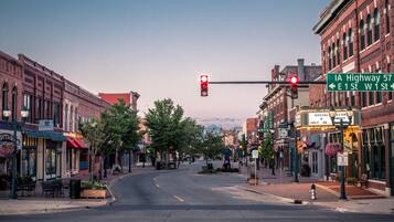 A street view with a traffic light, storefronts, and a sign for IA Highway 57.
