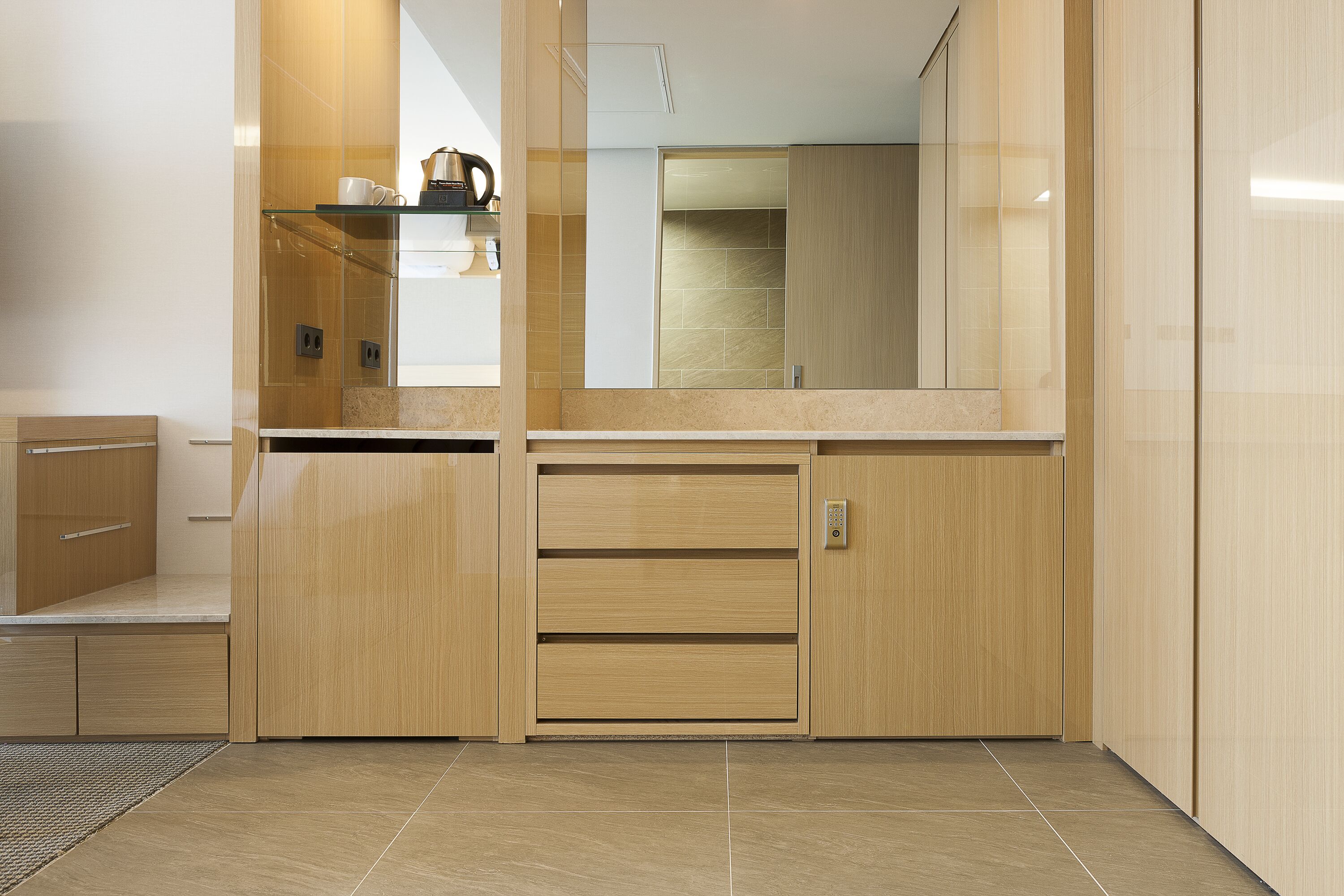 A modern kitchen with wooden cabinets, a countertop, and a built-in oven.