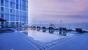 Seasonal outdoor pool, open 3:00 PM to 9:00 PM, pool loungers