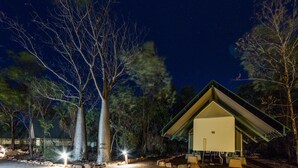 A single-story building with a sloped roof, surrounded by trees and a gravel path. - El Questro - Emma Gorge (Durack)