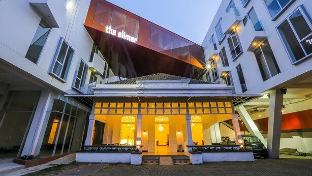 A modern building with a prominent sign reading "the alimar." - Alimar Hotel (Malang)