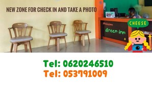 A Green Inn reception area with a check-in zone and a photo booth. - Chiangkhong Green Inn Residence (Chiang Khong)