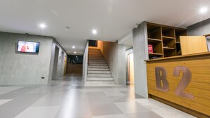 A hotel reception area with a staircase leading to the upper floors. - B2 Khon Kaen Boutique & Budget Hotel (Khon Kaen)