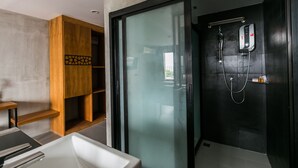 A modern bathroom with a glass shower enclosure, a wooden vanity, and a white bathtub. - B2 Khon Kaen Boutique & Budget Hotel (Khon Kaen)