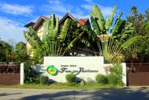 A building with a sign that reads "Frangipani Island".