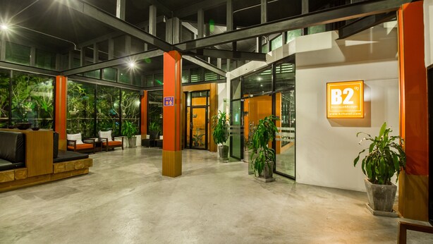 A hotel lobby with a reception desk, seating area, and potted plants. - B2 Chiang Rai Boutique & Budget Hotel (Chiang Rai)
