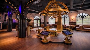 A modern interior with a large mechanical sculpture, wooden flooring, and seating areas. - Efteling Wonder Hotel - Theme Park tickets included (Kaatsheuvel)