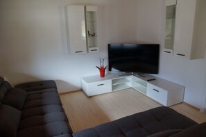Deluxe Suite, 2 Bedrooms, Balcony | Living room | Flat-screen TV, DVD player