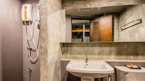 A bathroom with a shower, a sink, and a toilet.