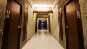 A hallway with doors numbered 501 and 506, leading to a room with a visible door at the end.