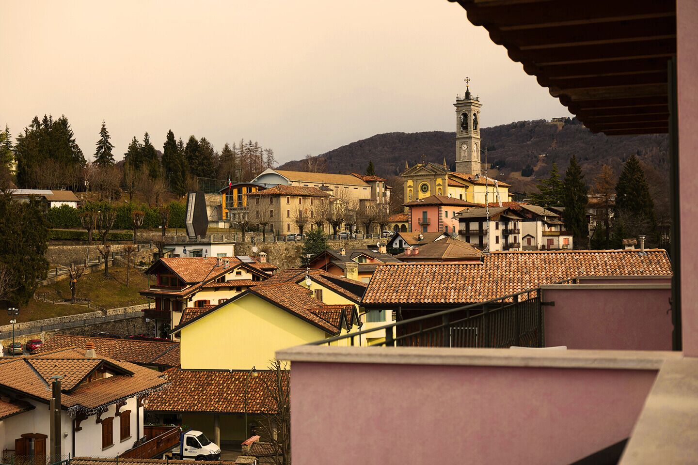 A town with traditional architecture, including a prominent church with a bell tower, surrounded by residential buildings with tiled roofs.
