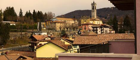 A town with traditional architecture, including a prominent church with a bell tower, surrounded by residential buildings with tiled roofs.