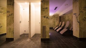 A hallway with a shower area and a seating area with chairs.