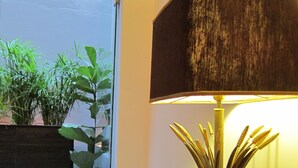 A wooden table with a lamp and a potted plant. - Concierge Monastiraki (Athens)
