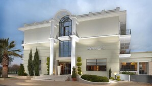 A modern hotel with a central entrance, large windows, and a symmetrical facade. - Danai Hotel & Spa (Katerini)