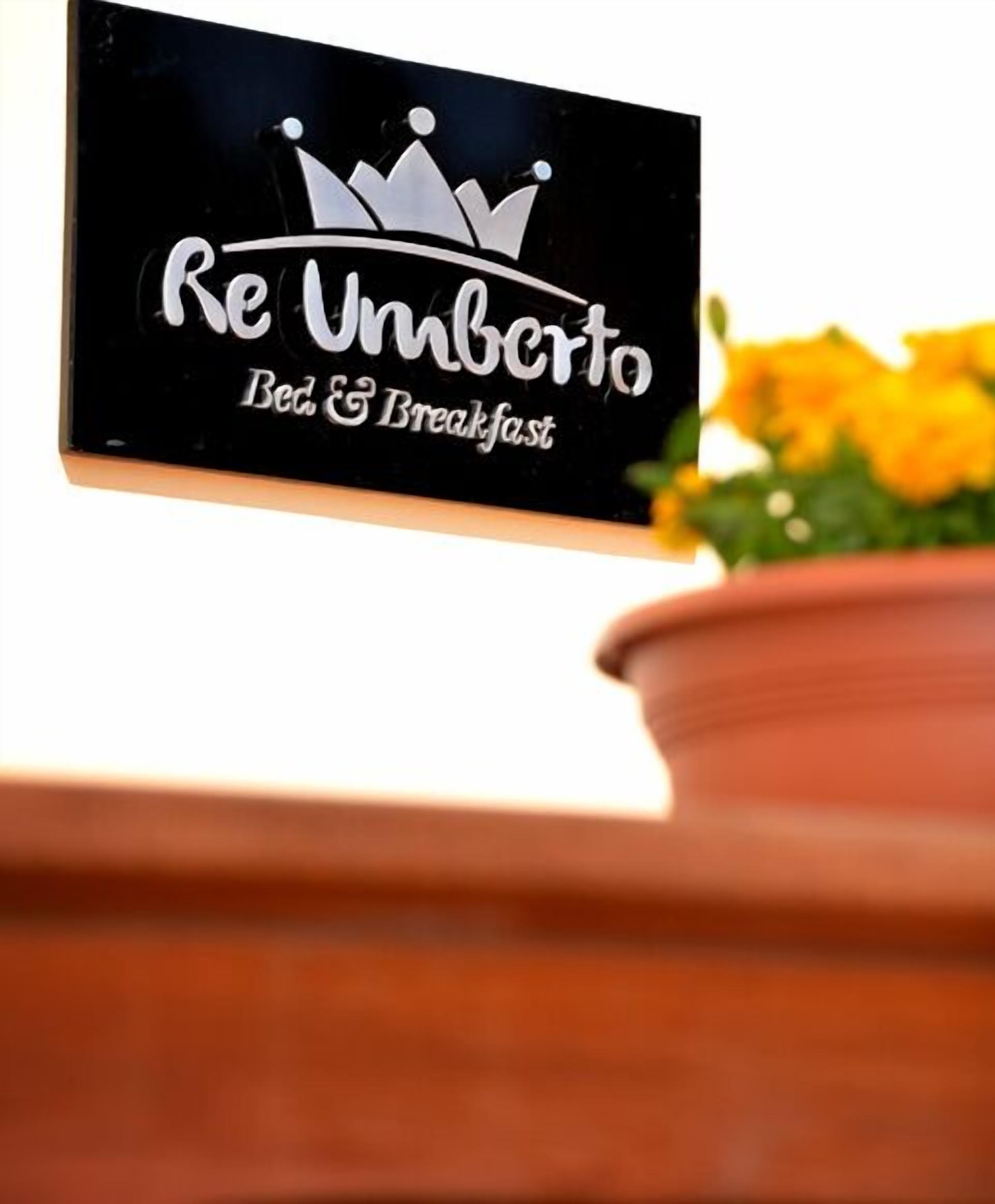 A sign for "Re Umberto Bed & Breakfast" with a crown graphic.
