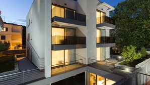 A modern multi-story residential building with balconies, large windows, and a well-lit exterior. - Residence by Vestibul Palace (Split)