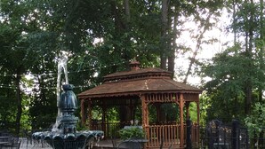 A gazebo with a fountain in a park setting. - Ginkgo Tree Inn (Mount Pleasant)