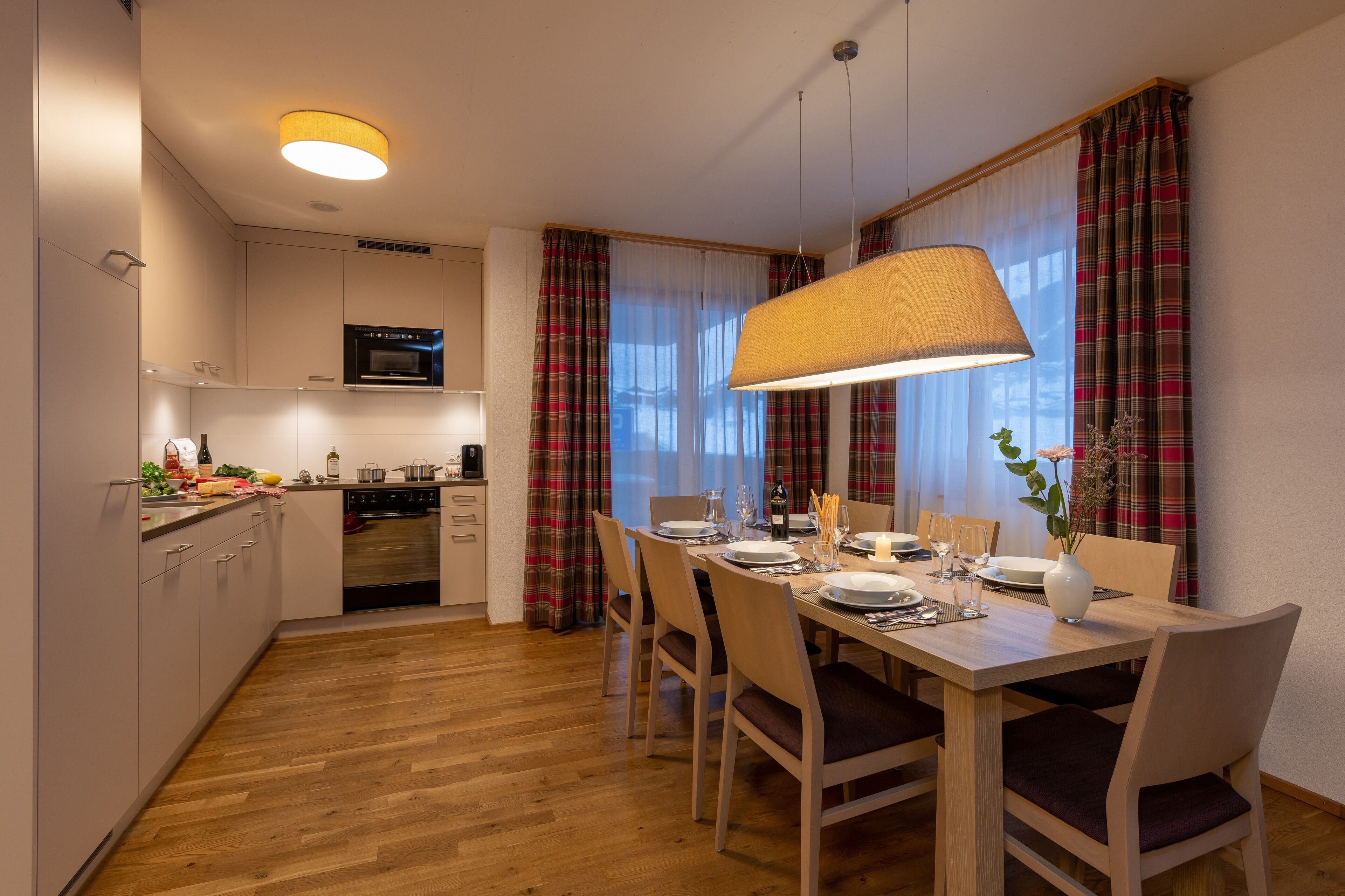 A modern kitchen with a dining area.
