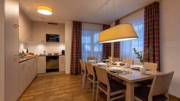 A modern kitchen with a dining area.