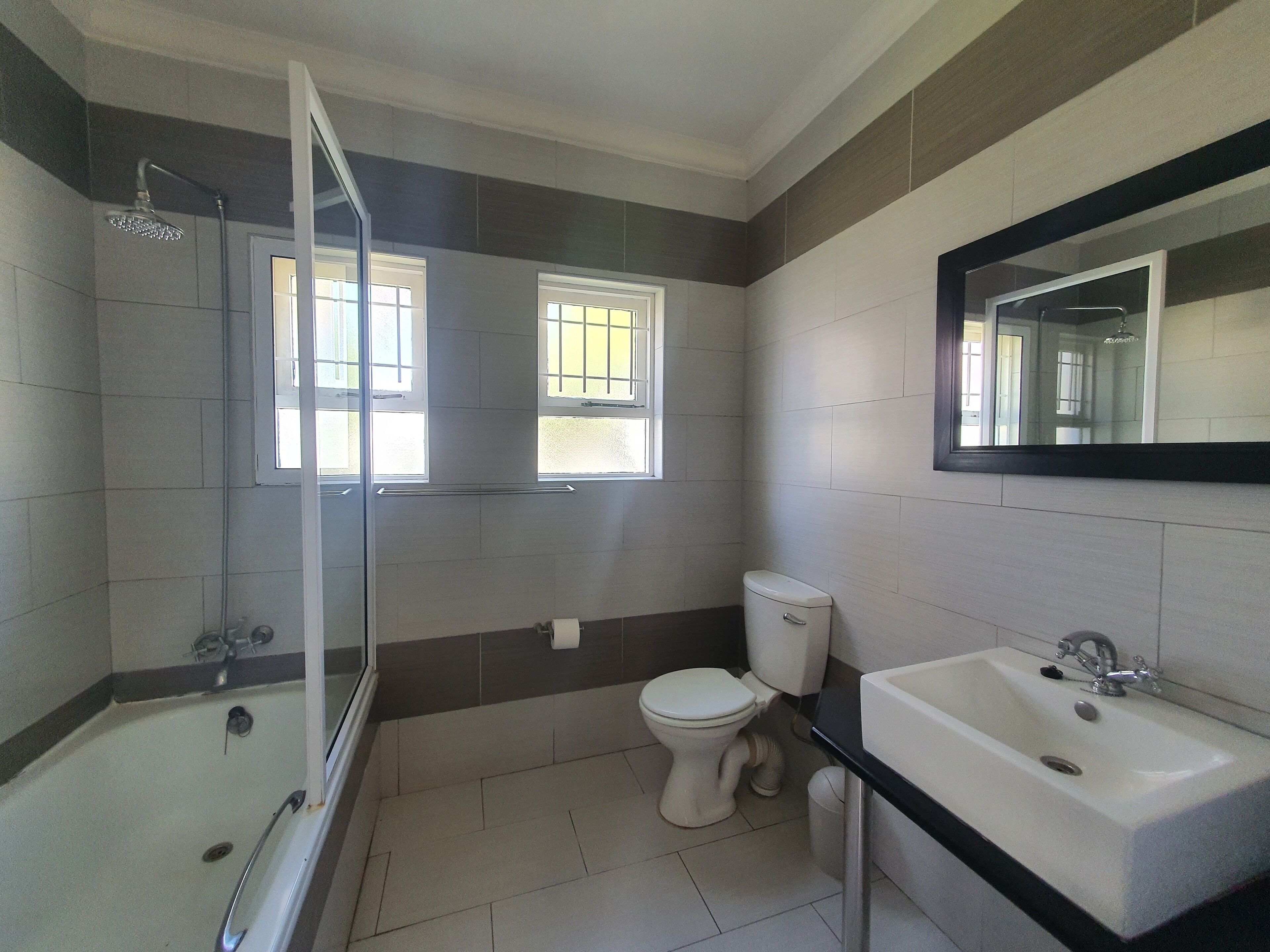 A bathroom with a bathtub, toilet, and sink.