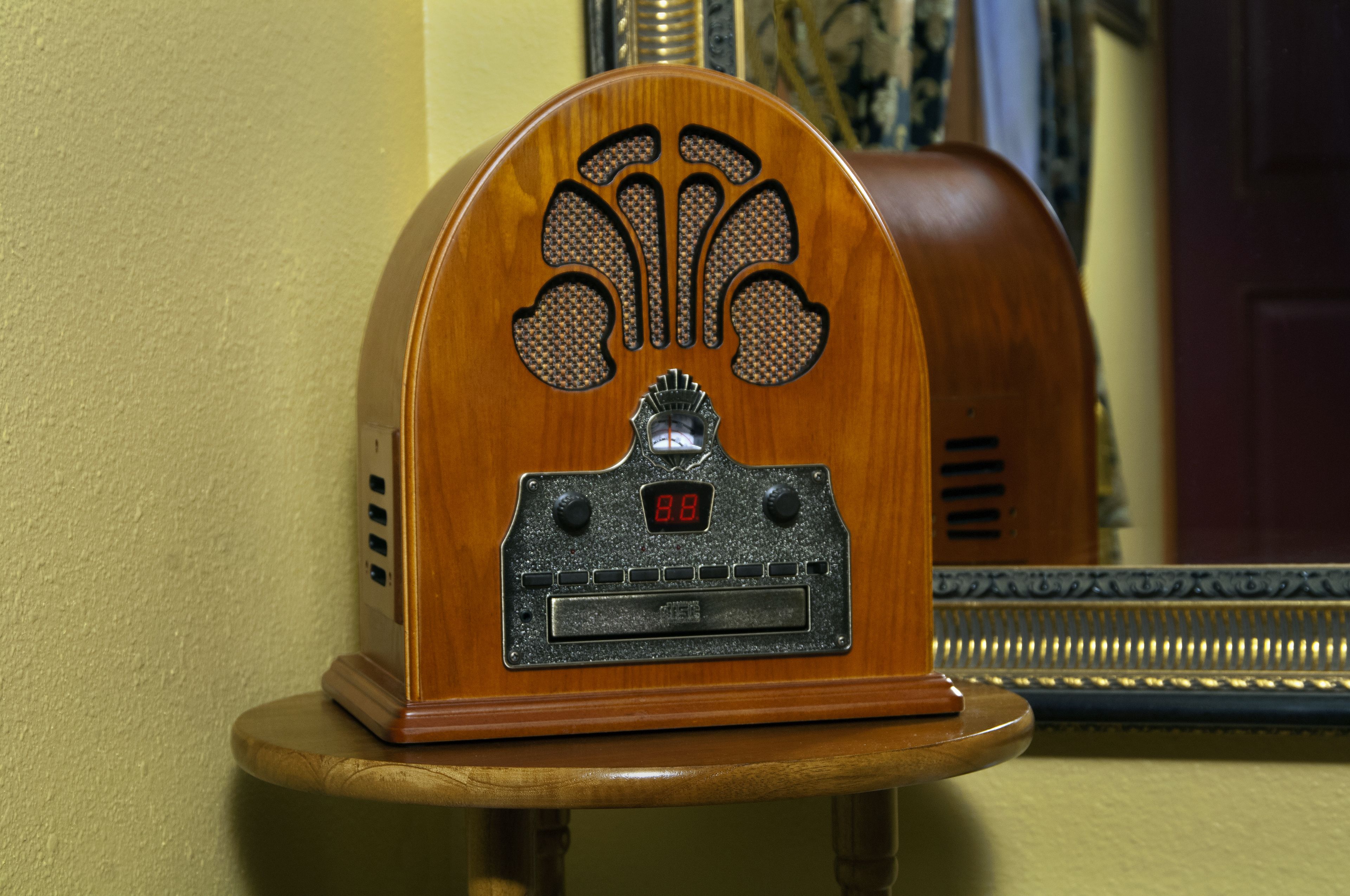 A vintage radio on a wooden stand.