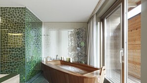 A modern bathroom with a freestanding bathtub, a glass shower enclosure, and a wooden vanity. - AROSEA Life Balance Hotel (Ultimo)