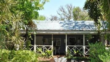 Relax on the covered porch amidst lush gardens.
