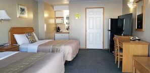 A hotel room with two beds, a desk with a television, a microwave, and a refrigerator. - Athabasca Lodge Motel (Athabasca)
