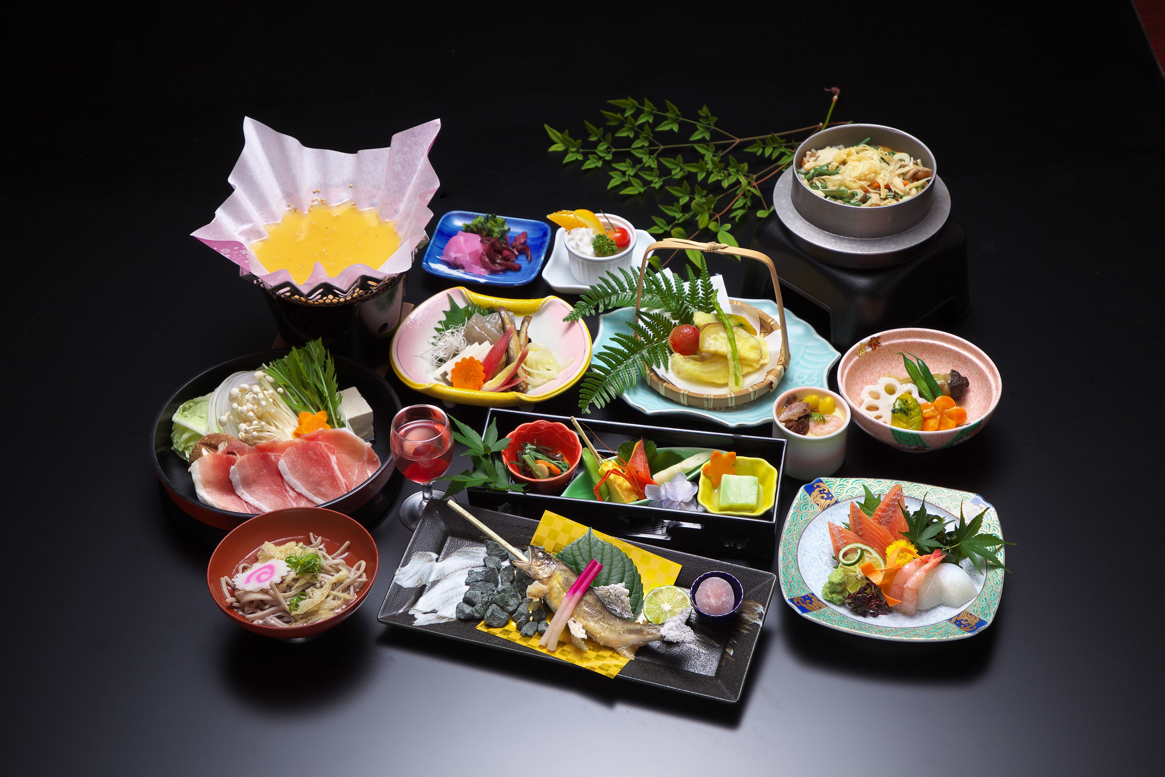 A variety of dishes and food items arranged on a table.