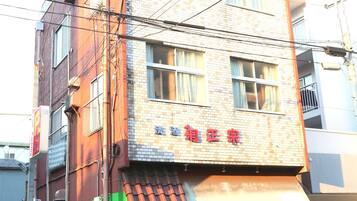A multi-story building with a storefront on the ground floor.