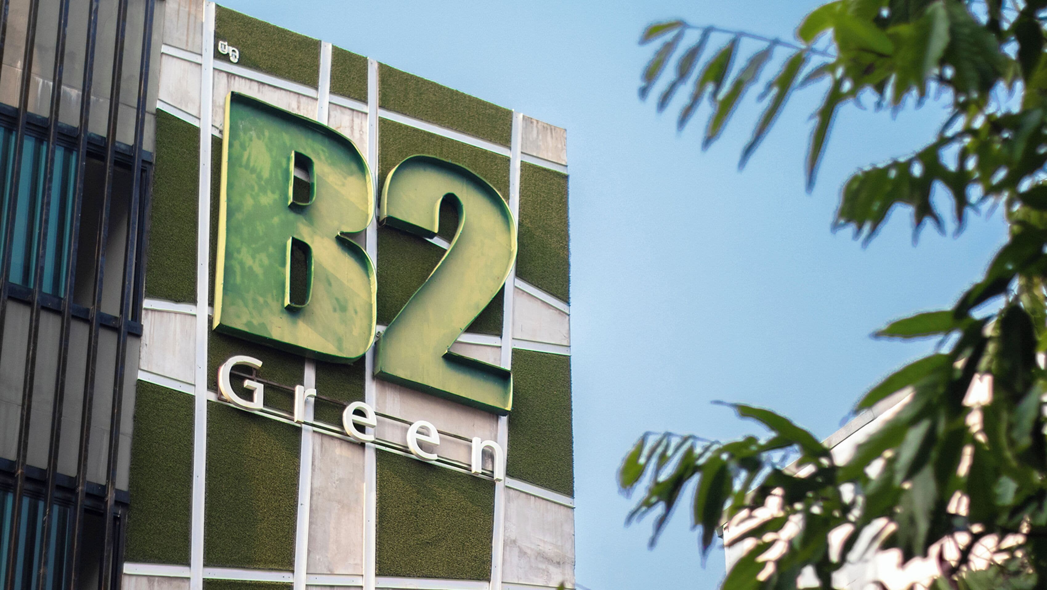 A building with the sign 'R2 Green' on its facade.