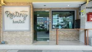 The exterior of a hostel with a large sign reading "Restiny hostel". - Restiny Hostel (Bangkok)