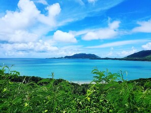 A coastal landscape with a clear view of the sea and distant mountains. - Guesthouse Ho Aloha - Hostel (Ishigaki)