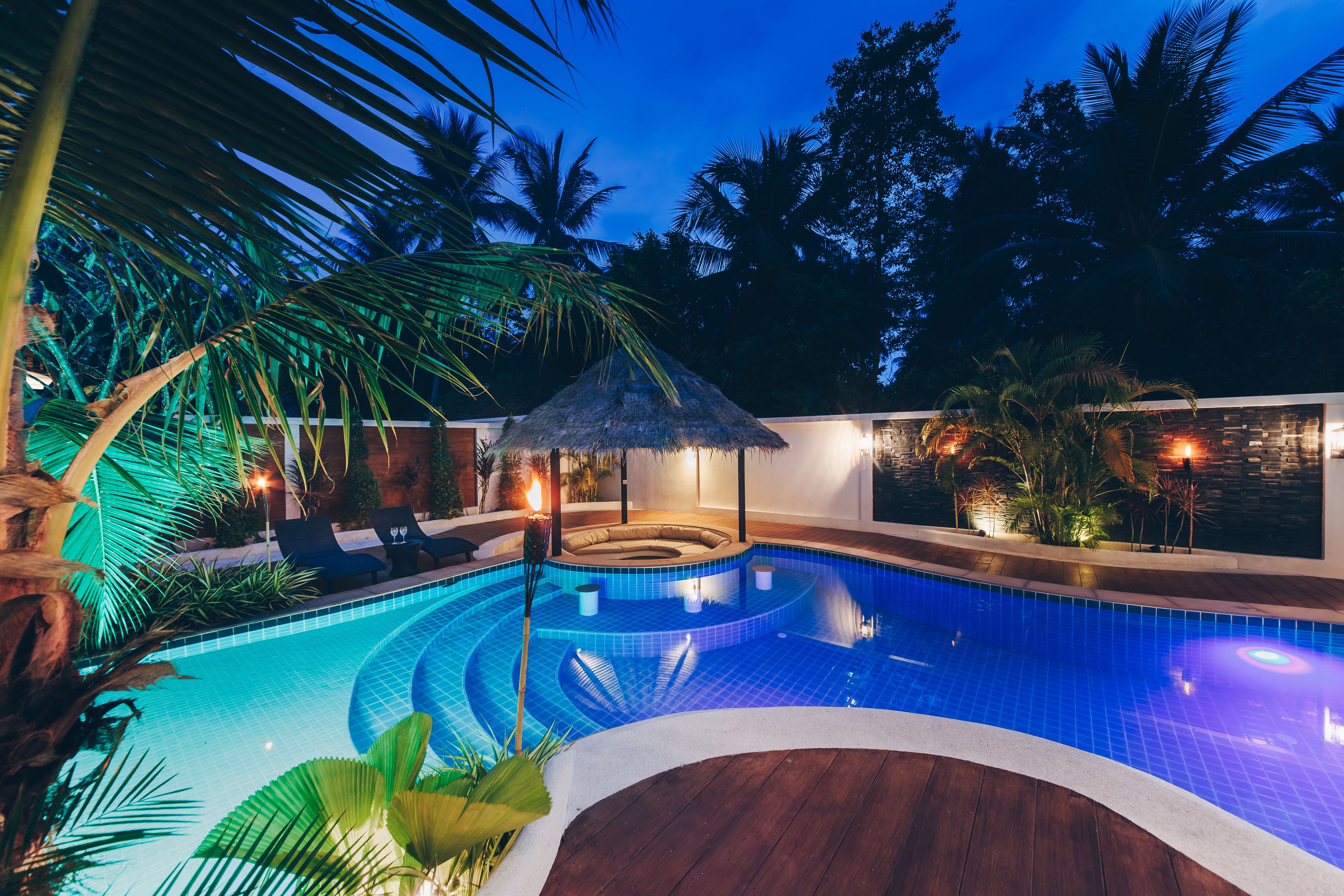 Una piscina al aire libre, sombrillas, tumbonas