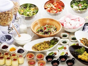 A variety of dishes and condiments arranged on a table, including salads, rice, and various sauces. - Kushiro Century Castle Hotel (Kushiro)