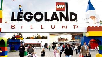 The entrance to Legoland Billund with LEGO figures on top of the structure.
