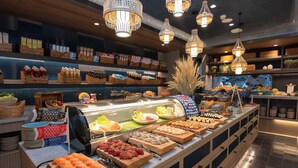 Een buffet met diverse gerechten en een sushi-hoek.
