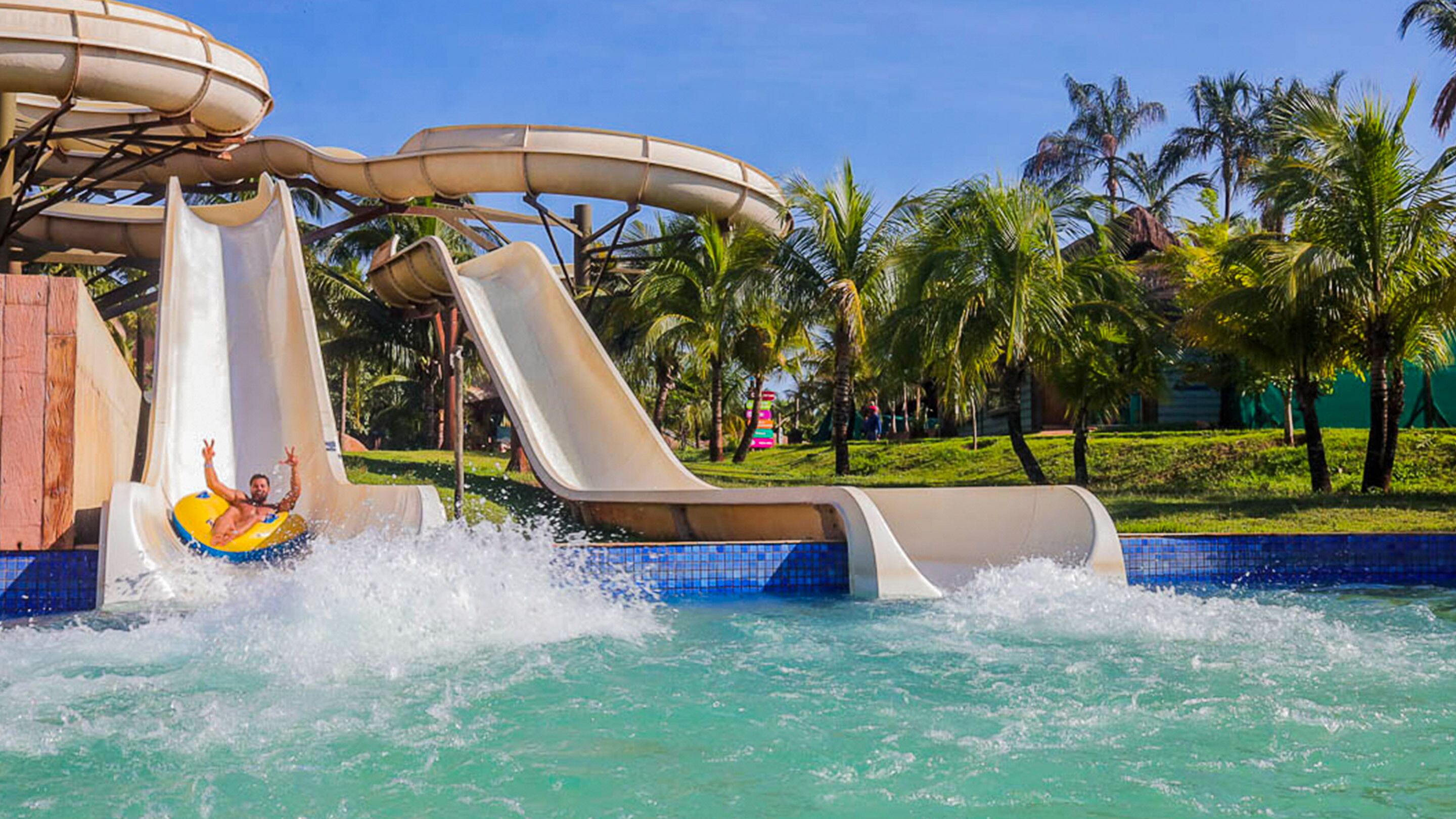 A water park with multiple water slides and a pool area.