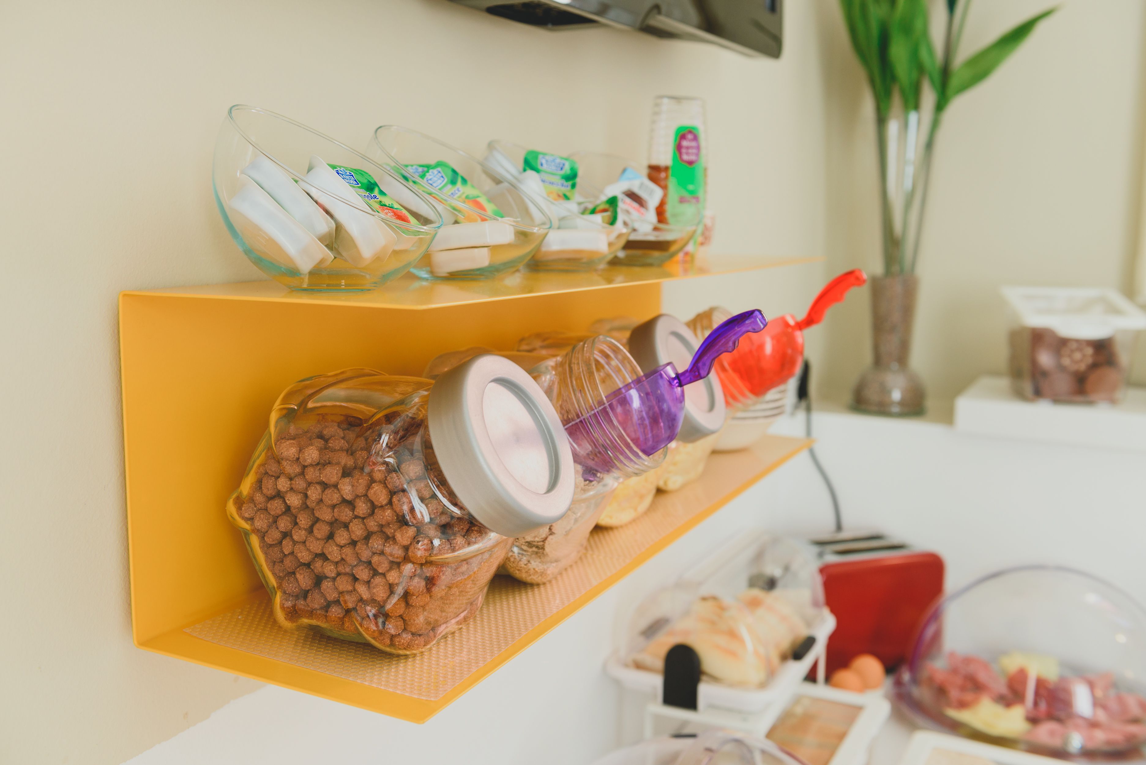 A breakfast bar with various food items and condiments.