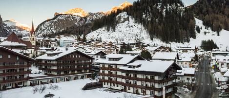 A snow-covered town with multiple buildings, including a hotel named 'Hotel Antares'.