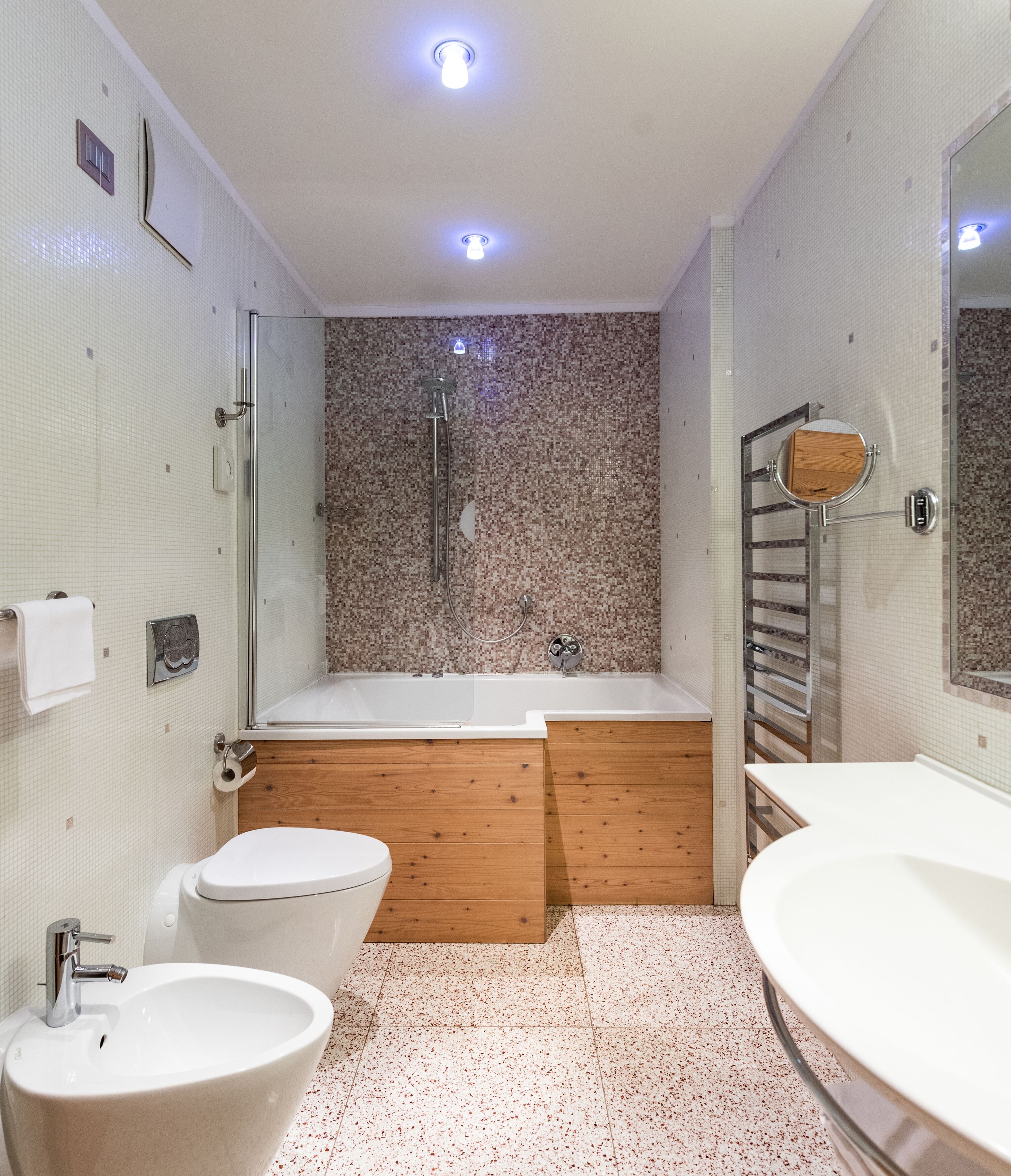 A modern bathroom with a bathtub, a toilet, and a sink.