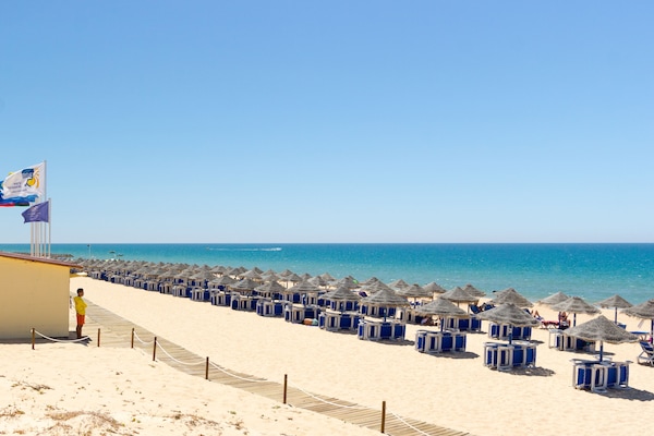 On the beach, sun loungers, beach umbrellas, beach towels
