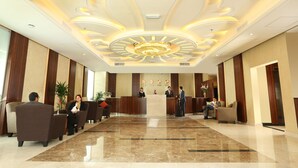 A hotel lobby with a reception desk, seating area, and a decorative ceiling. - Best Western Plus Salmiya (Salmiya)
