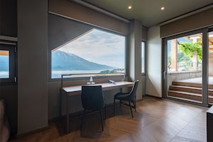 Romantic Suite, Lake View | Living area | TV