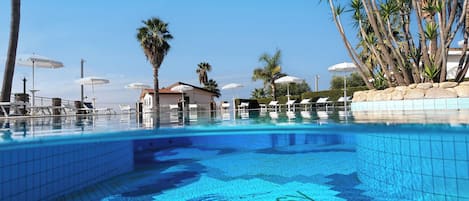 A swimming pool with a tiled floor featuring the word "ROYAL".